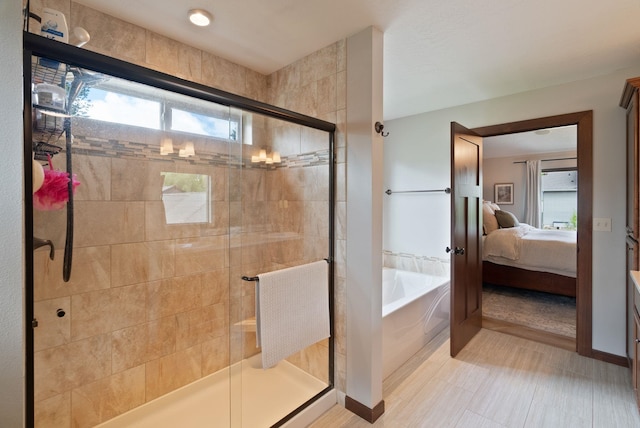 ensuite bathroom featuring a shower stall and a bath