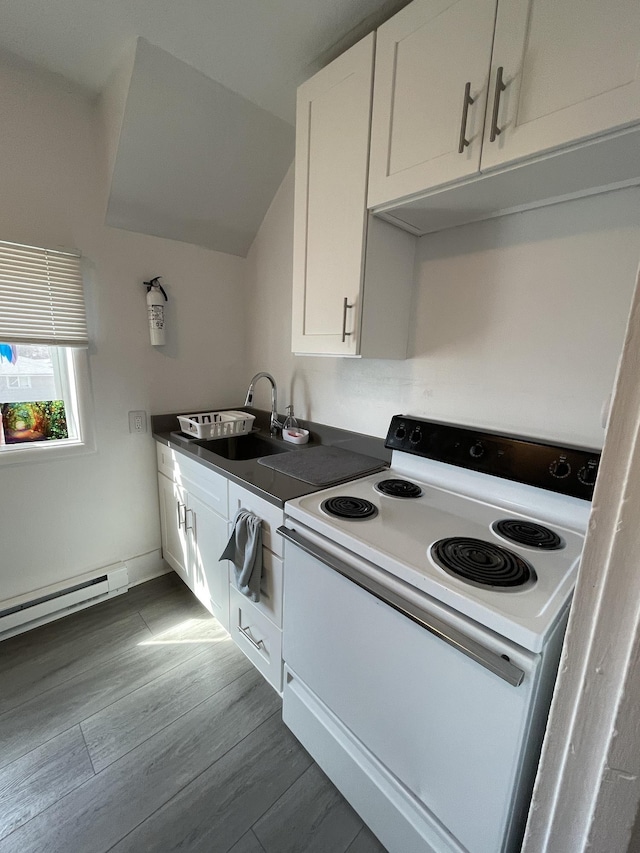 201 5th St, Cheney, WA 99004 - kitchen with white range with electric stovetop, a sink, white cabinetry, dark countertops, and wood finished floors
