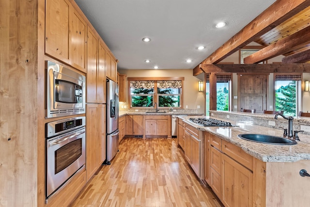 4224 E Hoffman Ln, Spokane, WA 99223 - kitchen with appliances with stainless steel finishes, a sink, light brown cabinetry, light wood-style floors, and recessed lighting