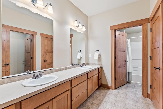 4224 E Hoffman Ln, Spokane, WA 99223 - bathroom featuring double vanity, tile patterned floors, a shower with shower curtain, and baseboards