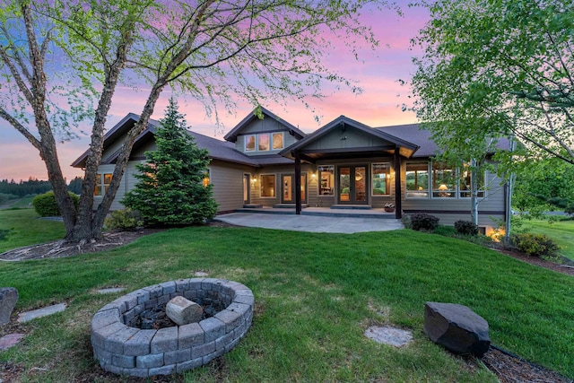 4224 E Hoffman Ln, Spokane, WA 99223 - back of house at dusk with a patio area, a lawn, and a fire pit