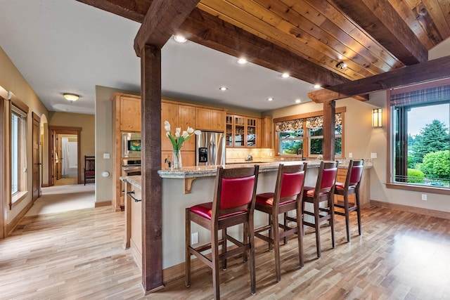 4224 E Hoffman Ln, Spokane, WA 99223 - kitchen featuring appliances with stainless steel finishes, baseboards, light wood finished floors, healthy amount of natural light, and beam ceiling