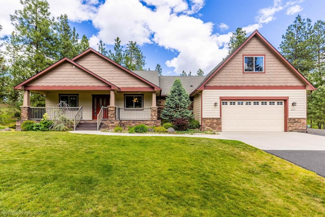 craftsman-style home with concrete driveway, an attached garage, stone siding, and a front yard