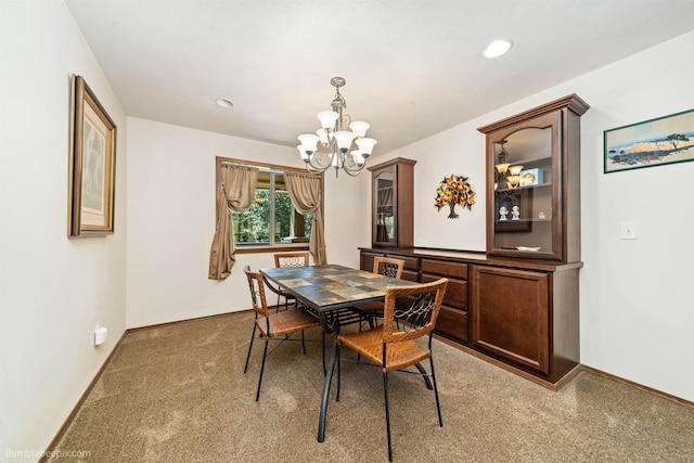 carpeted dining area with a chandelier, baseboards, and recessed lighting