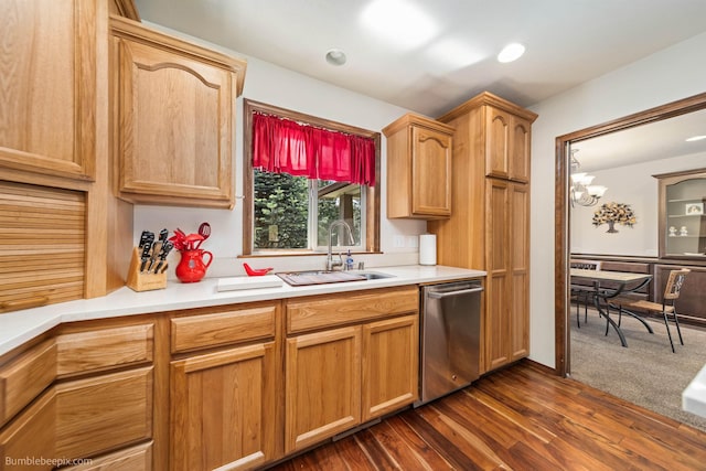 kitchen with stainless steel dishwasher, a sink, light countertops, and a chandelier
