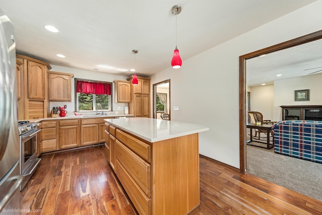 kitchen with stainless steel appliances, a sink, light countertops, dark wood-style flooring, and recessed lighting