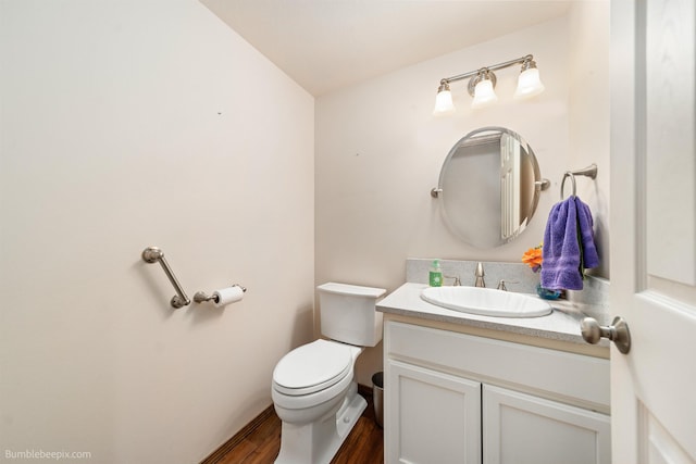 bathroom featuring vanity, toilet, and wood finished floors