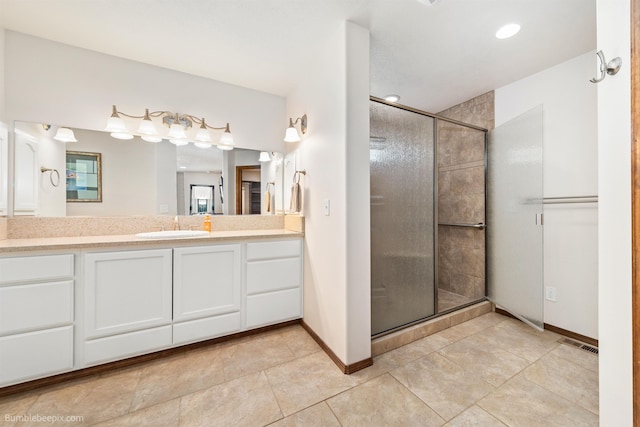 full bath featuring a shower stall, vanity, baseboards, and recessed lighting
