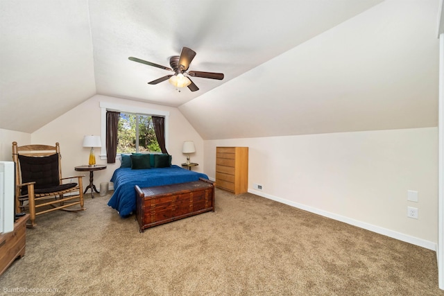 carpeted bedroom featuring vaulted ceiling, baseboards, and a ceiling fan