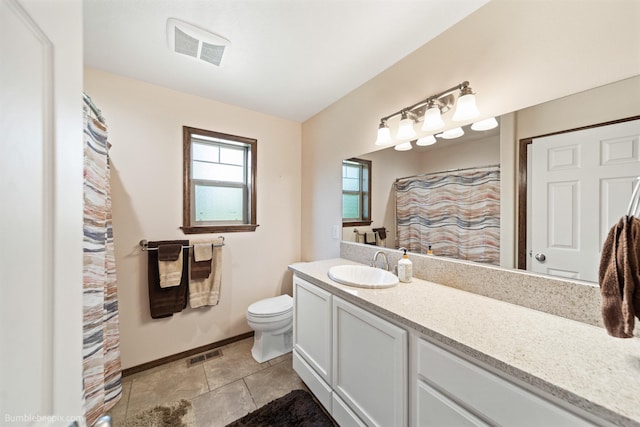 bathroom featuring toilet, vanity, baseboards, and curtained shower