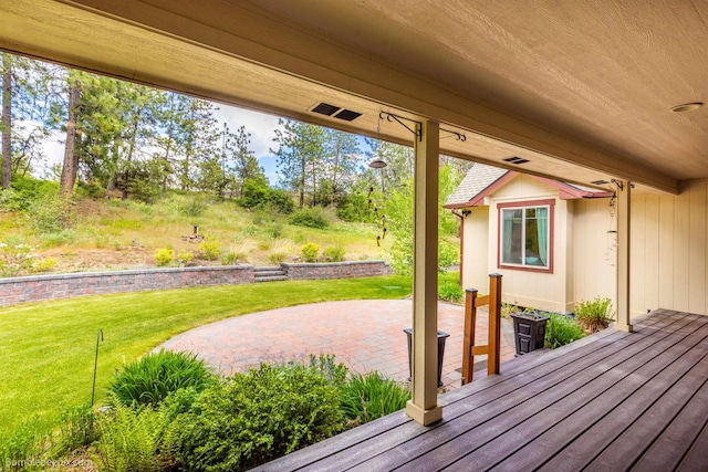 wooden terrace with a patio area and a yard