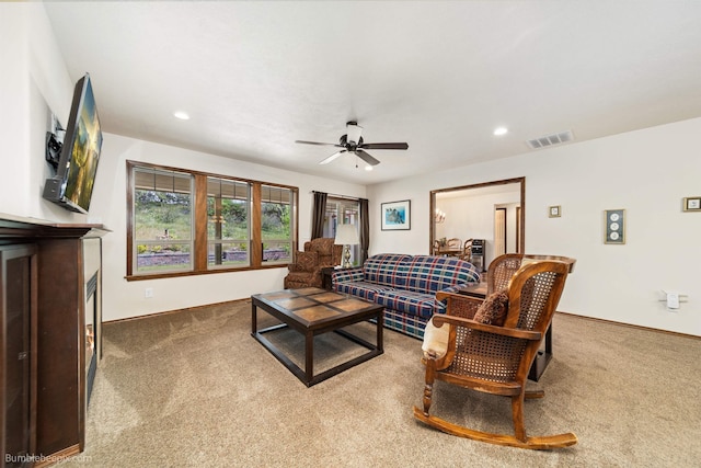 carpeted living area with ceiling fan, baseboards, and recessed lighting
