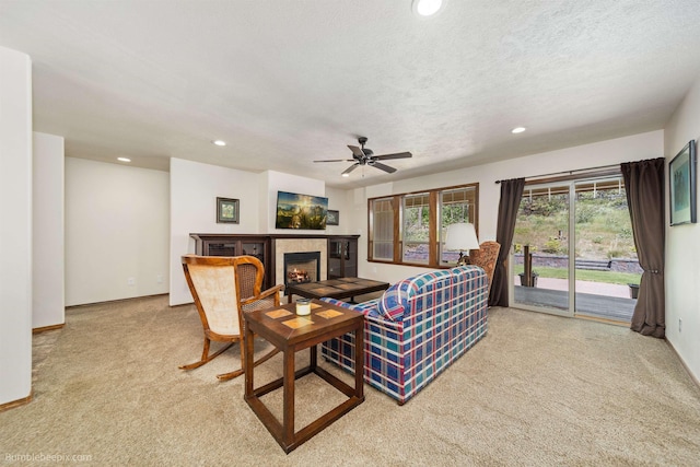 living area with carpet flooring, recessed lighting, a fireplace, ceiling fan, and baseboards