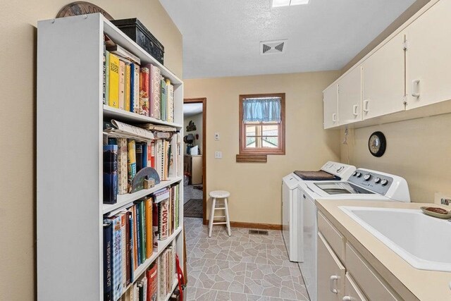 2059 Dry Creek Rd, Chewelah, WA 99109 - laundry room featuring independent washer and dryer, baseboards, cabinet space, and a textured ceiling