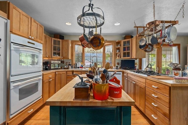 2059 Dry Creek Rd, Chewelah, WA 99109 - kitchen with double oven, butcher block countertops, light wood-style floors, healthy amount of natural light, and recessed lighting