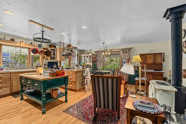 2059 Dry Creek Rd, Chewelah, WA 99109 - kitchen featuring plenty of natural light, light wood finished floors, recessed lighting, a wood stove, and butcher block countertops
