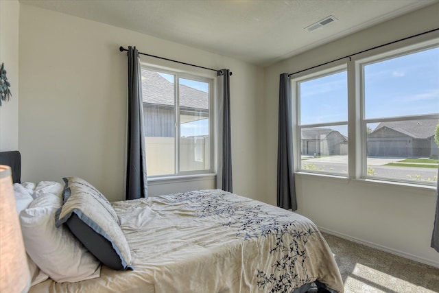 14621 E Sanson Ave, Spokane Valley, WA 99216 - carpeted bedroom with multiple windows and baseboards