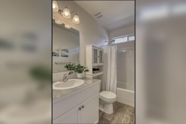 14621 E Sanson Ave, Spokane Valley, WA 99216 - bathroom with toilet, wood finished floors, vanity, and shower / bath combo