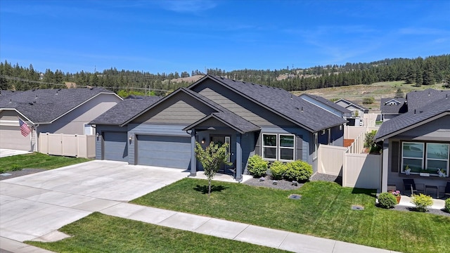 14621 E Sanson Ave, Spokane Valley, WA 99216 - ranch-style home with an attached garage, driveway, and a wooded view