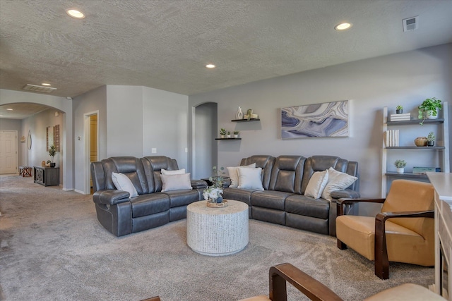 14621 E Sanson Ave, Spokane Valley, WA 99216 - living room featuring arched walkways, carpet, recessed lighting, baseboards, and a textured ceiling