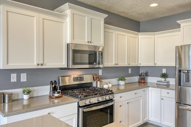 14621 E Sanson Ave, Spokane Valley, WA 99216 - kitchen featuring stainless steel appliances, white cabinetry, light countertops, a textured ceiling, and recessed lighting