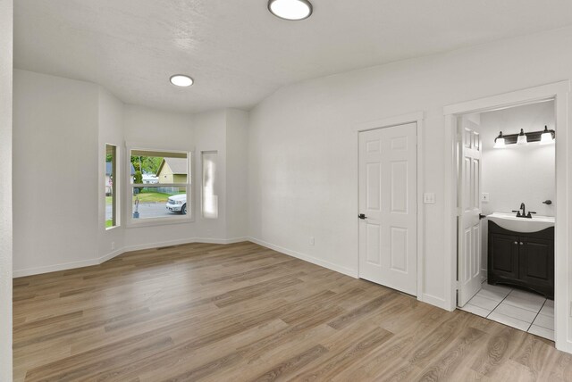 13704 E Heroy Ave, Spokane Valley, WA 99216 - empty room with a sink, light wood-type flooring, and baseboards