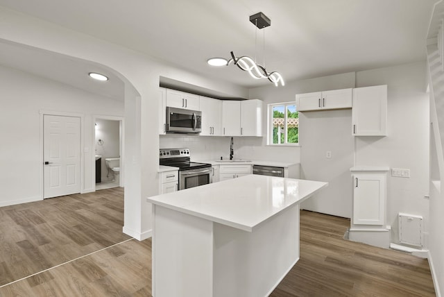13704 E Heroy Ave, Spokane Valley, WA 99216 - kitchen featuring stainless steel appliances, white cabinetry, a sink, and wood finished floors