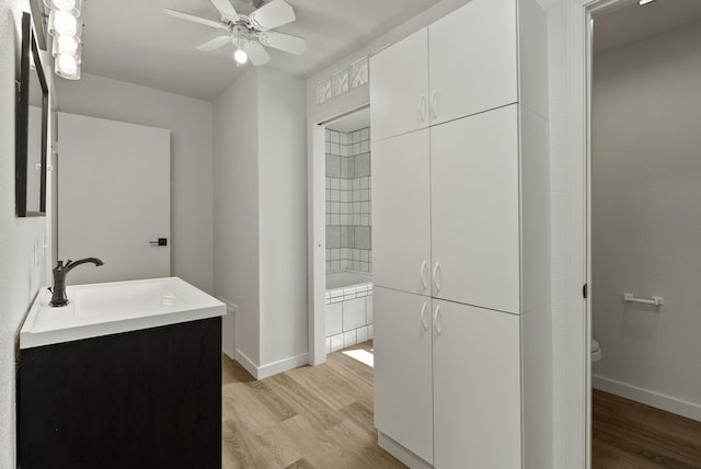 13704 E Heroy Ave, Spokane Valley, WA 99216 - bathroom featuring wood finished floors, baseboards, toilet, and ceiling fan
