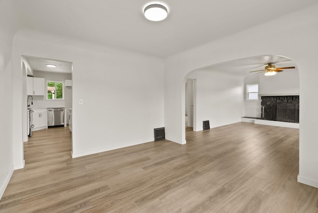 13704 E Heroy Ave, Spokane Valley, WA 99216 - unfurnished living room featuring a ceiling fan, light wood-type flooring, and plenty of natural light