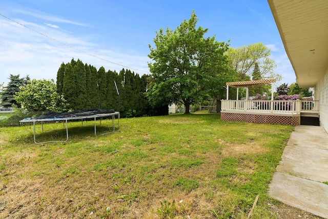 13704 E Heroy Ave, Spokane Valley, WA 99216 - view of grassy yard featuring a trampoline, a deck, and a pergola