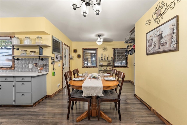 dining room featuring dark wood finished floors, baseboards, and a chandelier