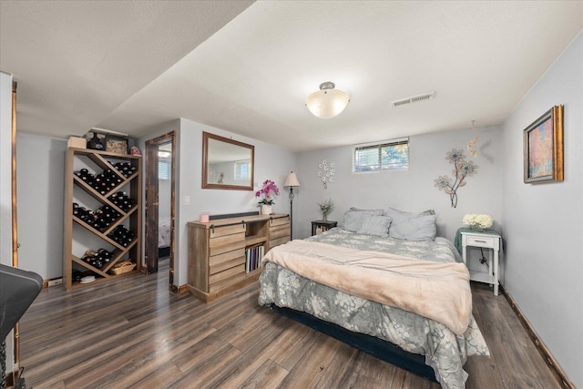 bedroom with wood finished floors and baseboards