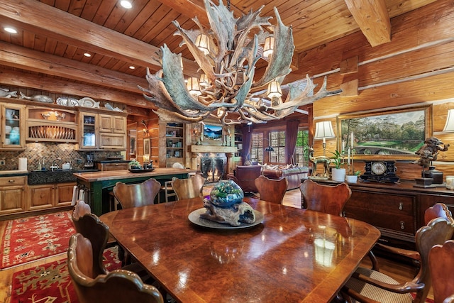 10351 N Gibson Rd, Hayden, ID 83835 - dining area featuring beamed ceiling, recessed lighting, wood ceiling, a chandelier, and wooden walls