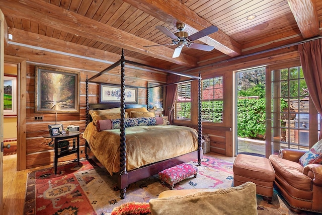 10351 N Gibson Rd, Hayden, ID 83835 - bedroom with wood ceiling, beam ceiling, wooden walls, and wood finished floors
