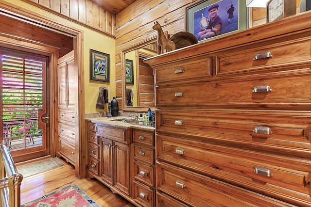 10351 N Gibson Rd, Hayden, ID 83835 - bathroom featuring wood finished floors, vanity, and wood walls