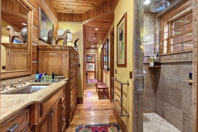 10351 N Gibson Rd, Hayden, ID 83835 - hallway featuring a sink, light wood-style flooring, recessed lighting, and wooden ceiling