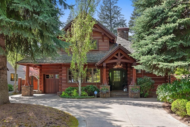 10351 N Gibson Rd, Hayden, ID 83835 - view of front of property with a chimney and curved driveway
