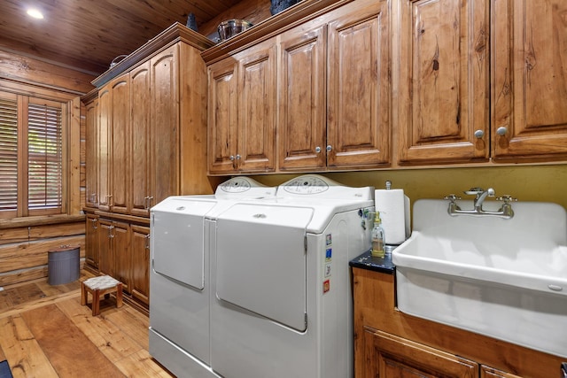 10351 N Gibson Rd, Hayden, ID 83835 - clothes washing area with washer and clothes dryer, cabinet space, and light wood-style floors