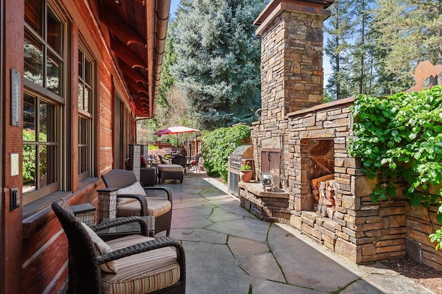10351 N Gibson Rd, Hayden, ID 83835 - view of patio / terrace featuring an outdoor stone fireplace and area for grilling
