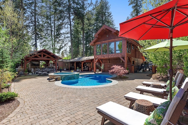 10351 N Gibson Rd, Hayden, ID 83835 - view of swimming pool featuring a gazebo, a patio, and a pool with connected hot tub