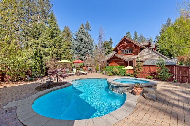 10351 N Gibson Rd, Hayden, ID 83835 - view of swimming pool with fence, a patio area, and a pool with connected hot tub