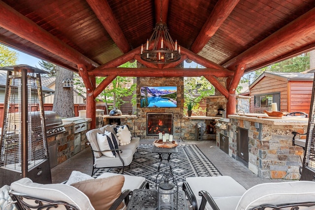 10351 N Gibson Rd, Hayden, ID 83835 - view of patio / terrace featuring an outdoor stone fireplace, exterior kitchen, a gazebo, and fence