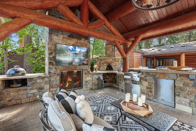 10351 N Gibson Rd, Hayden, ID 83835 - view of patio featuring an outdoor stone fireplace and area for grilling