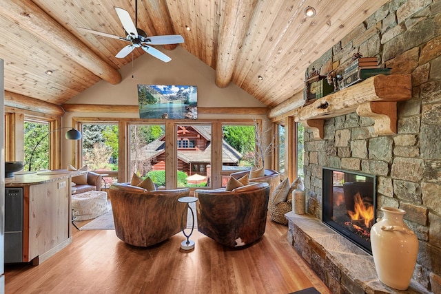 10351 N Gibson Rd, Hayden, ID 83835 - living room featuring beam ceiling, wooden ceiling, a fireplace, wood finished floors, and a ceiling fan