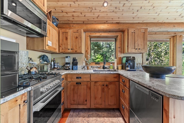 10351 N Gibson Rd, Hayden, ID 83835 - kitchen featuring stainless steel appliances, a sink, a peninsula, light stone counters, and wooden ceiling