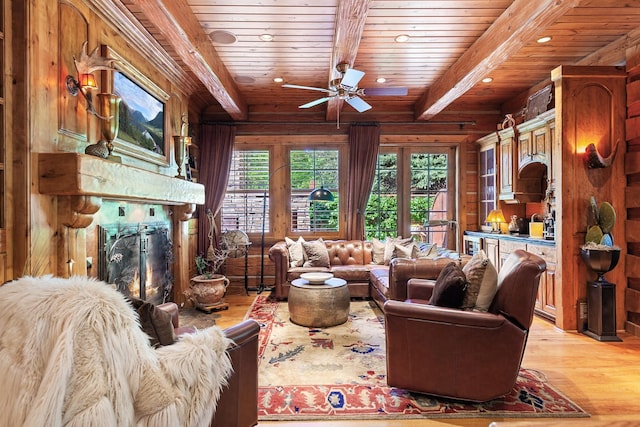 10351 N Gibson Rd, Hayden, ID 83835 - living area with light wood-style flooring, beam ceiling, wooden ceiling, a warm lit fireplace, and recessed lighting