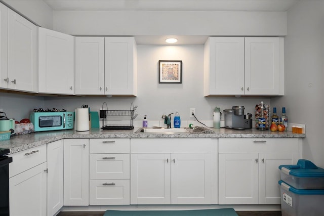 11707 E Broadway Ave, Spokane, WA 99206 - kitchen featuring a sink and white cabinets