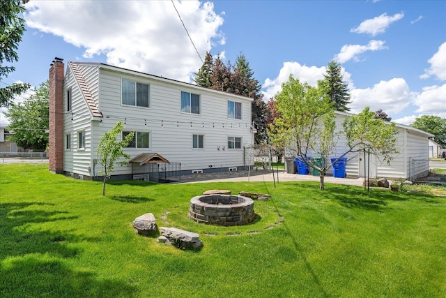 11707 E Broadway Ave, Spokane, WA 99206 - back of house with a fire pit and a chimney