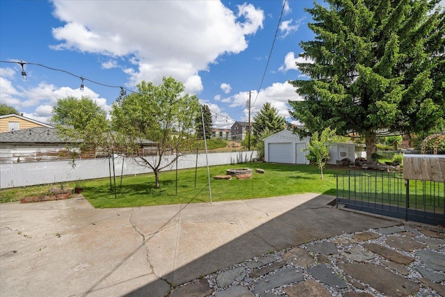 11707 E Broadway Ave, Spokane, WA 99206 - view of patio / terrace featuring a detached garage, a fire pit, and an outdoor structure