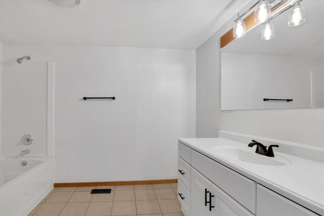 bathroom featuring baseboards, vanity, tile patterned floors, and washtub / shower combination